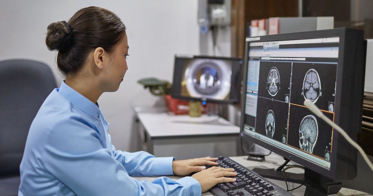 A radiologist examining digital X-ray images