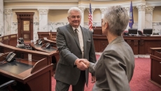 Two people shaking hands in a government building