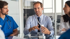 Healthcare professionals talking to pharmaceutical representative