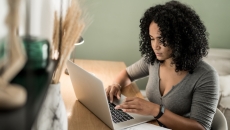 A woman doing research on a laptop computer