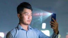 Person holding a phone while it scans their face