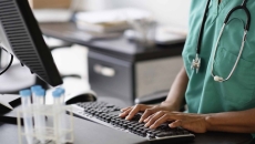 Healthcare professional working at a computer
