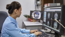 A radiologist examining digital X-ray images
