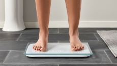 A person standing on the Cardiac Scale.