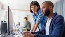 Business people looking at a desktop computer