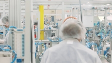 Workers in a Cue Health manufacturing facility