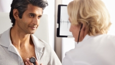 A healthcare professional using an Eko stethoscope with a patient