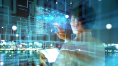 Person looking at images projected onto a wall with a city in the background