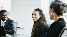 Three people sitting around a table