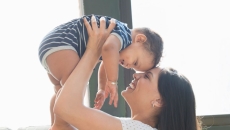 Person holds infant in arms