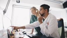 Healthcare professionals examining computer screen.