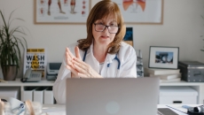 Healthcare professional interacting via laptop computer