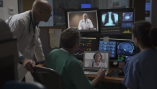 Healthcare professionals reviewing data on computer screens