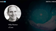 Mika Newton, xCures_Doctor's hand holding brain with AI chip Photo by Marco Marca/iStock/Getty Images Plus