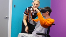 A nurse assisting a patient using the Evenness VR during an intervention session