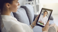 Person interacting with a healthcare professional via tablet