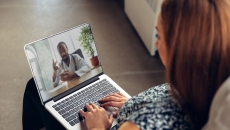 Patient consulting with healthcare professional virtually