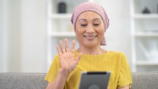 Person waving at tablet