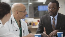 Clinicians in discussion with administrator