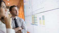 Businesspeople looking at financial charts