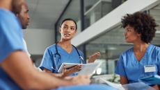A group of medical practitioners having a discussion in a hospital.