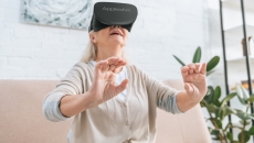 A woman using an AppliedVR headset at home