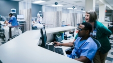Providers using a computer in a hospital.