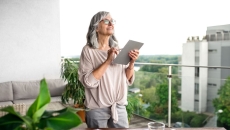A woman using a tablet at her desk
