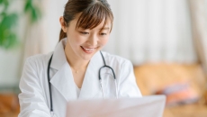 Healthcare provider sitting at a desk looking at a computer