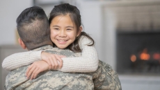 Solider hugging another person
