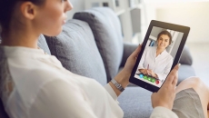 Person speaking to a healthcare provider via a tablet