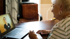 Person talking with nurse on laptop