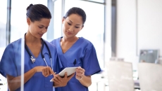 Nurses using a mobile tablet