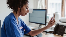 A doctor talking with a patient on a video call on her smartphone.