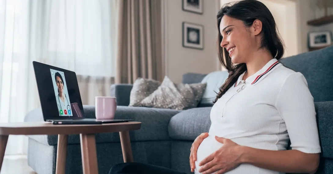 Pregnant women consulting with a healthcare professional via laptop computer