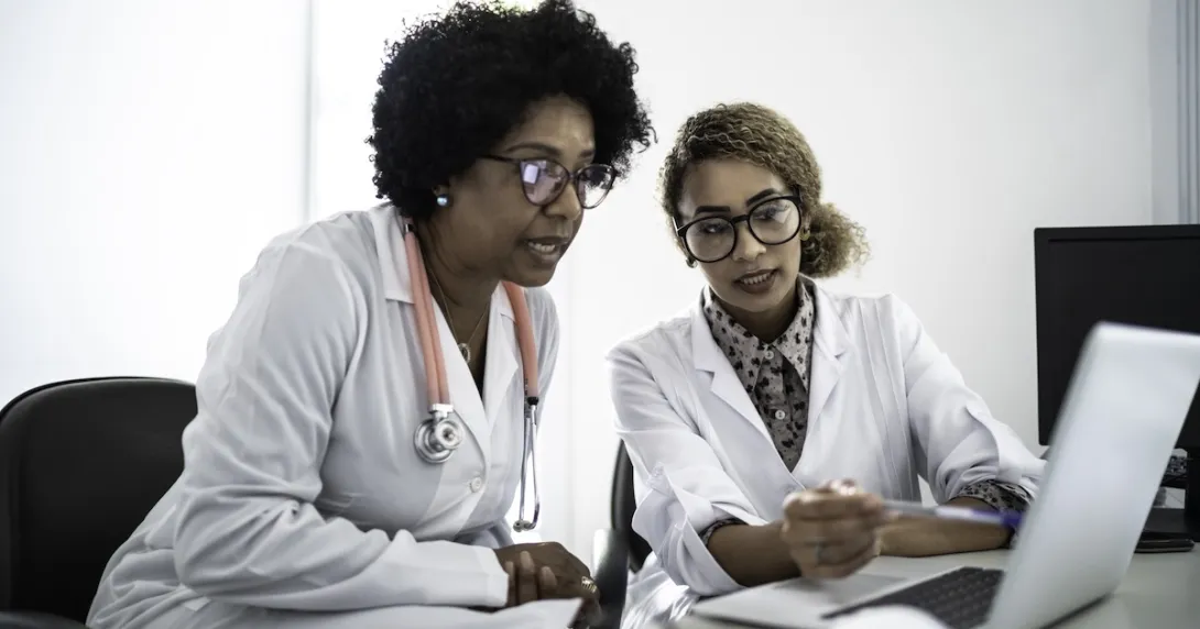 Healthcare professionals reviewing data on a labtop 