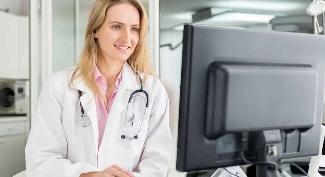 Healthcare provider looking at a computer