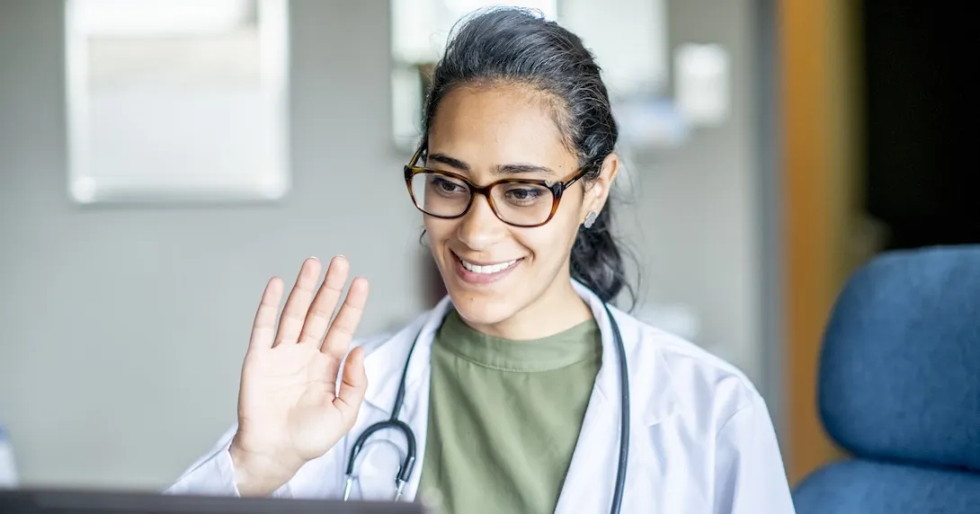 Healthcare professional engaging remotely via a laptop computer