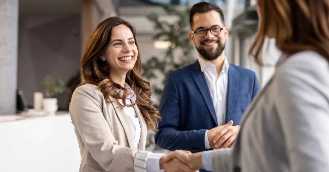 Businesswomen shaking hands during a meeting with a businessman
