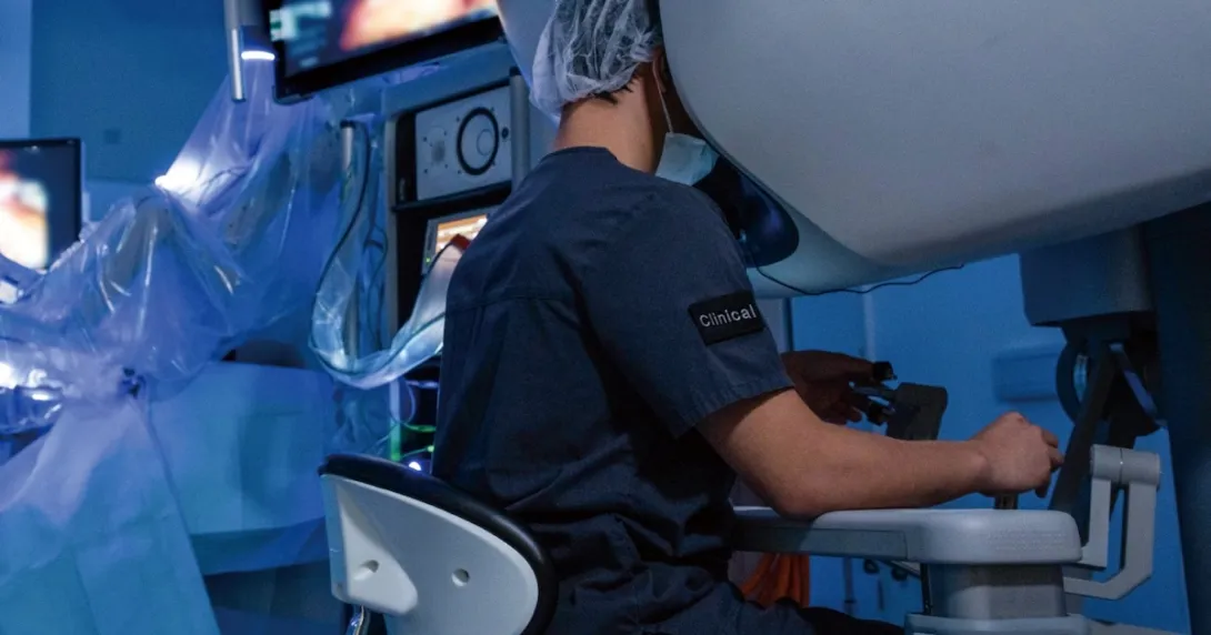 A surgeon operating using robotic technology