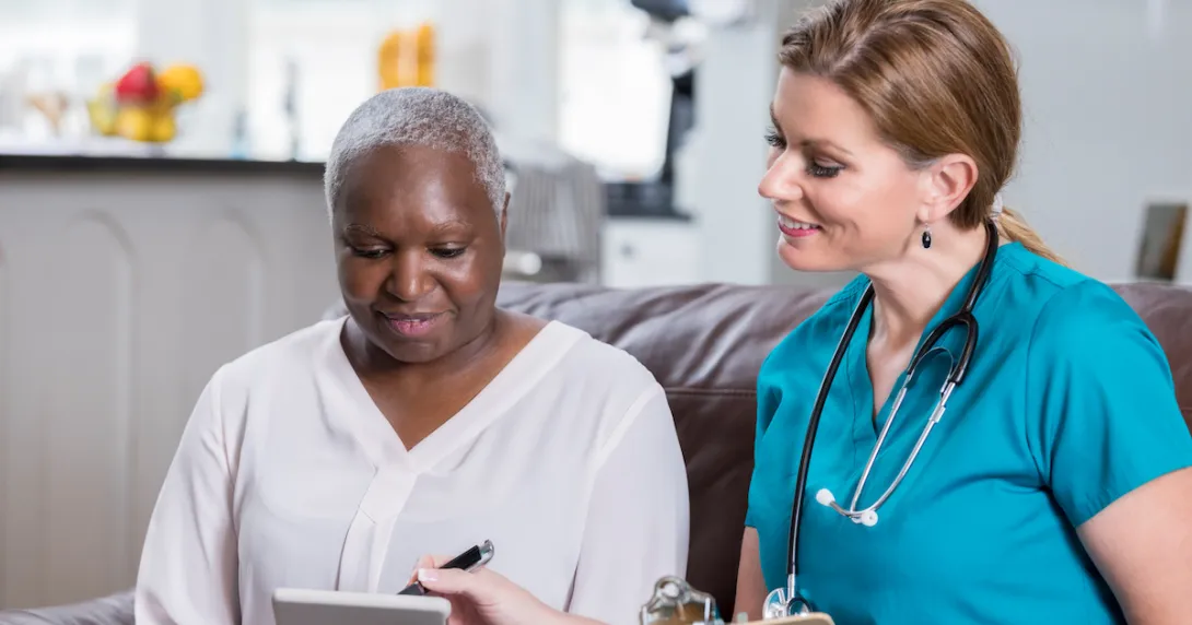 Healthcare professional and patent in an in-home visit