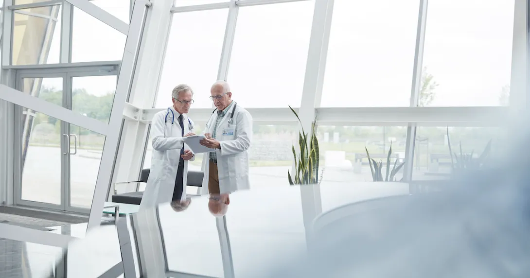 Two healthcare researchers speaking with each other
