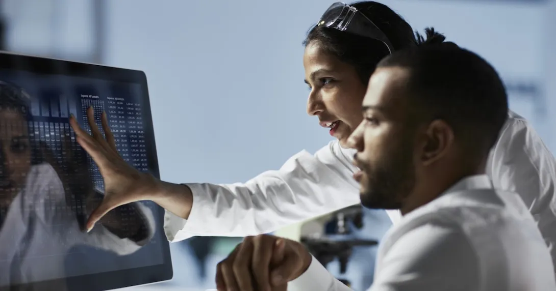 Healthcare professionals reviewing data on a PC