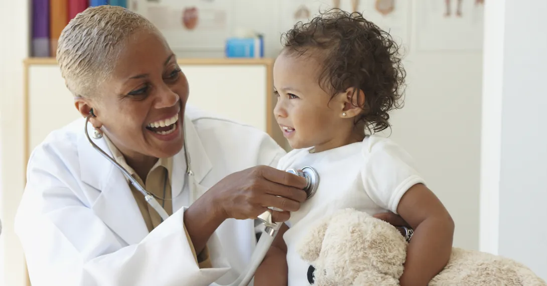 Doctor listens to baby's heart