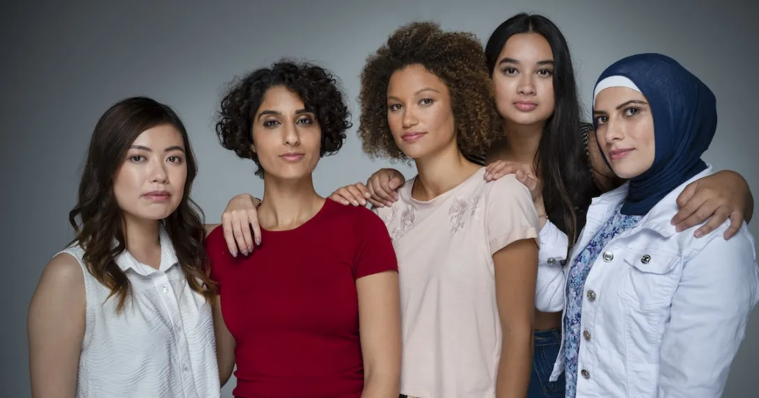 Five people standing by each other