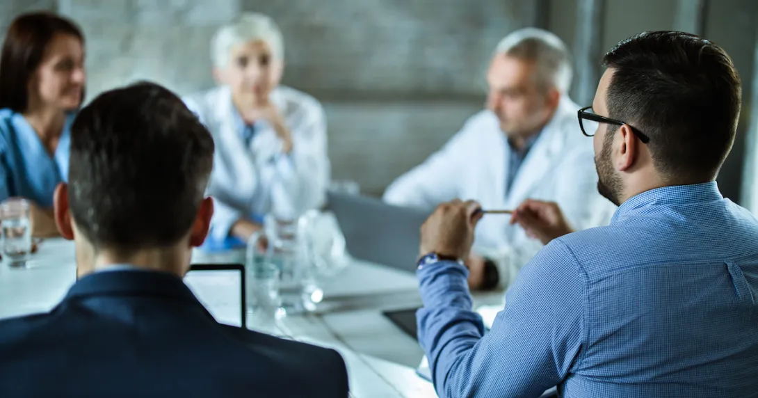 Business persons sitting around a table
