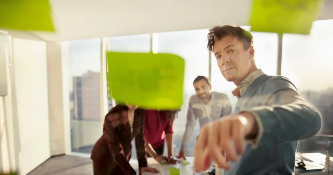 People looking at sticky notes