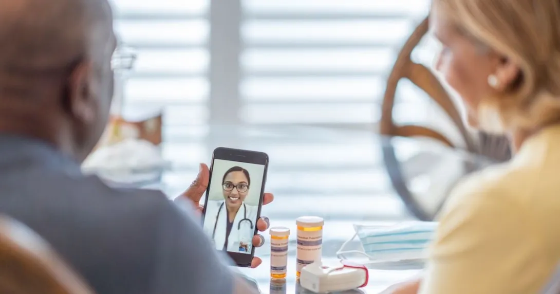 A man and a woman using a smartphone to talk to a provider