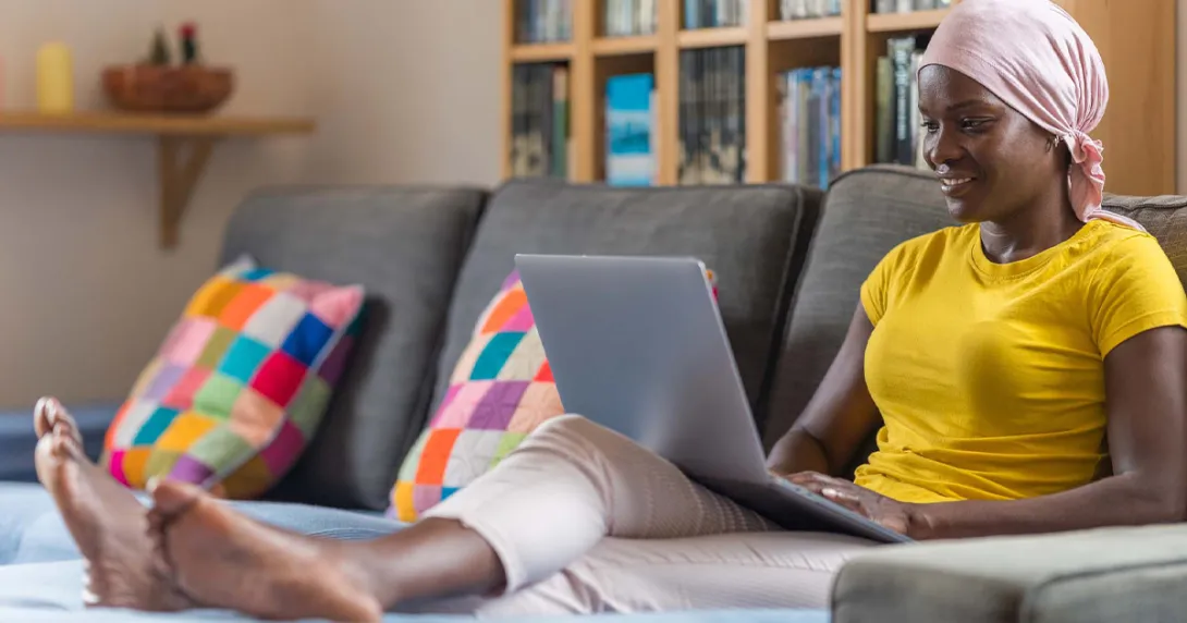 Person using laptop on a couch