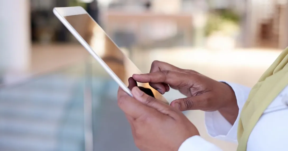 A close up shot of a woman using a tablet